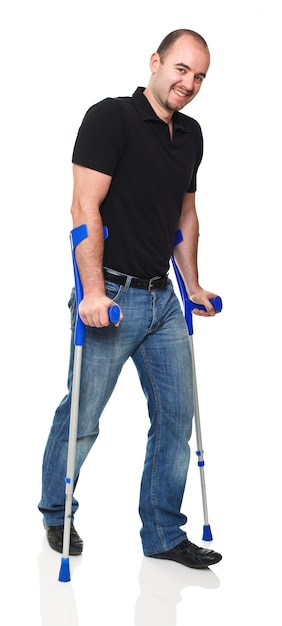 Man with crutch on white