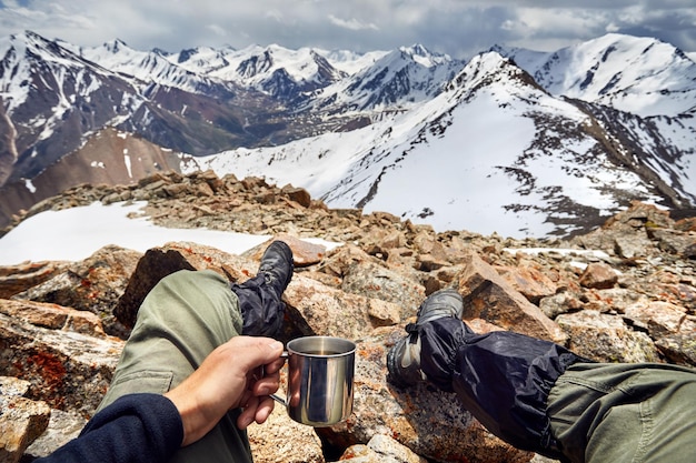 Man with cup in the mountain