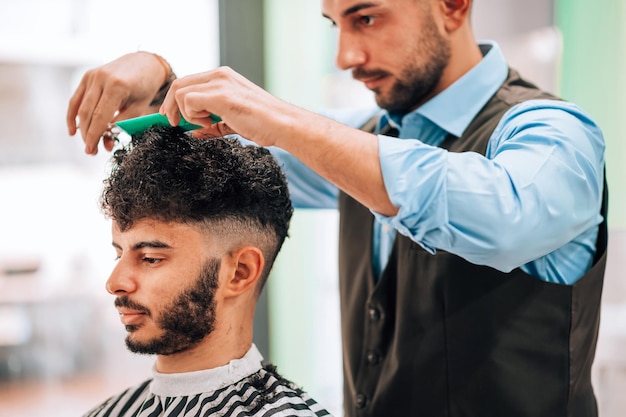 Man with dark hair having haircut