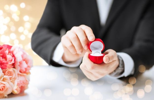 man with diamond engagement ring in red gift box