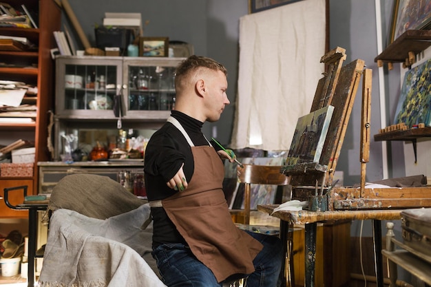 A man with disabilities draws pictures and is engaged in art