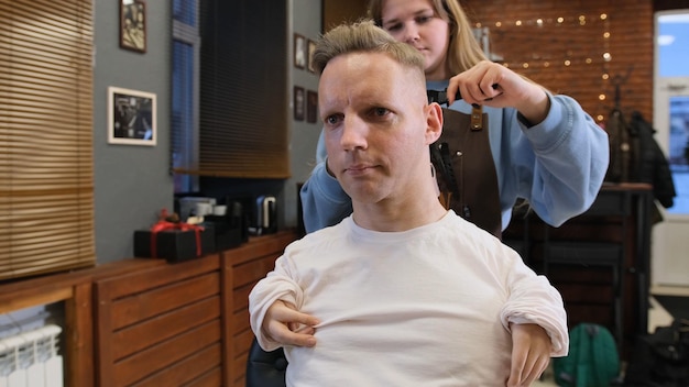 A man with disabilities gets his hair cut and styled in a barber shop