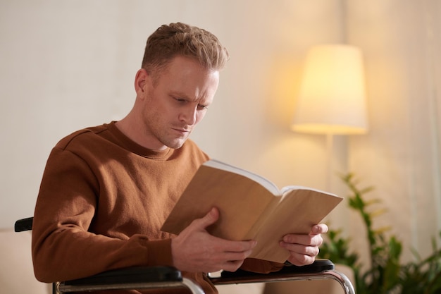 Man with disability reading book