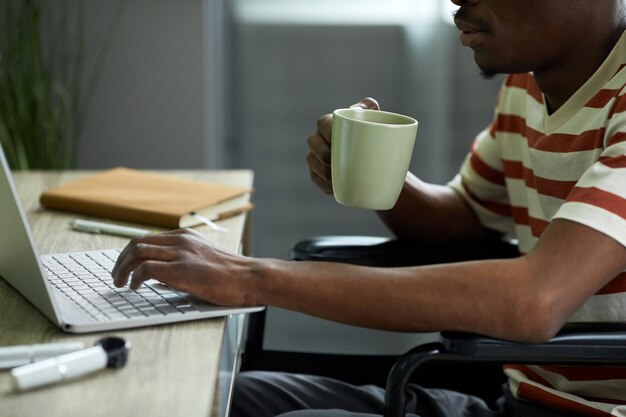 Photo man with disability working from home closeup