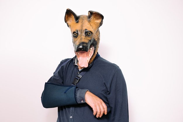 Man with dog mask and arm in a sling due to injury