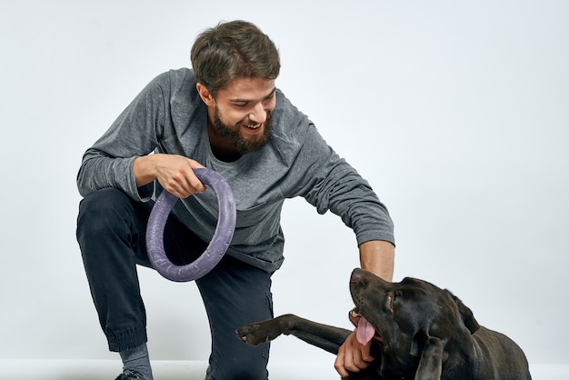 Man with dog training with gray ring