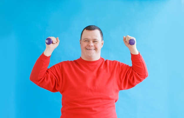 A man with down syndrome on an isolated blue background