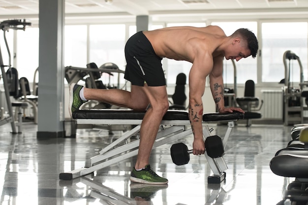 Man With Dumbbells Exercising Back