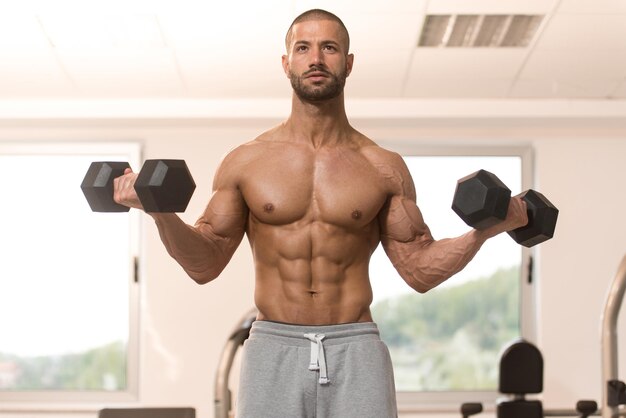 Man With Dumbbells Exercising Biceps