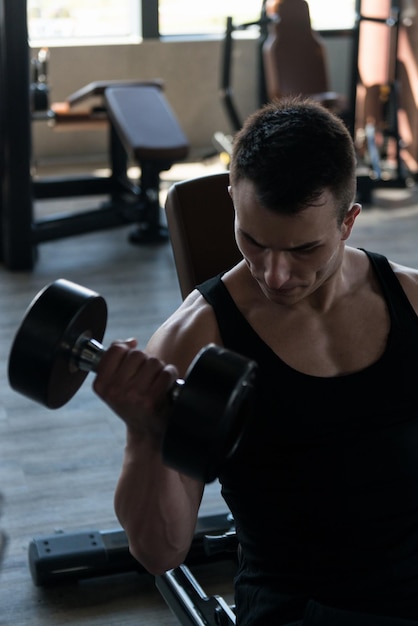 Man With Dumbbells Exercising Biceps