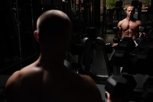 Man With Dumbbells Exercising Biceps