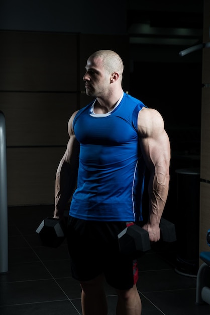 Man With Dumbbells Exercising Biceps