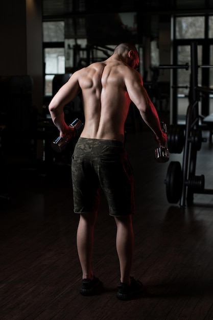 Man With Dumbbells Exercising Shoulders