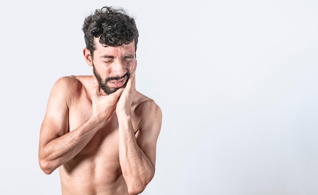 Man with earache on isolated background ear disease concept Person with earache on isolated background