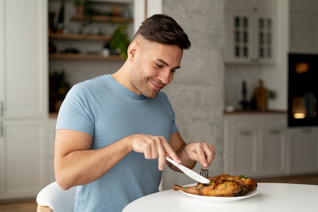 Man with eating disorder trying to eat chicken