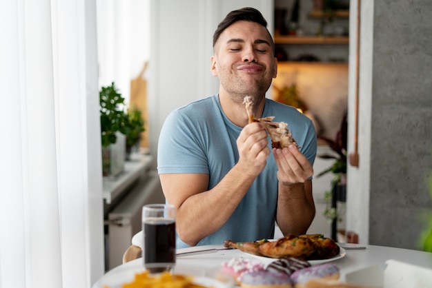 Photo man with eating disorder trying to eat chicken