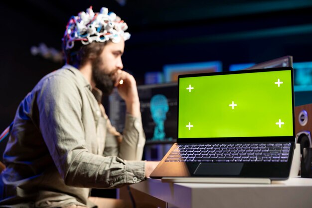 Man with EEG headset transferring mind into virtual world chroma key laptop