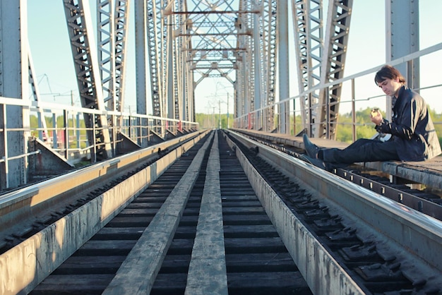 a man with an electric guitar in the industrial landscape outdoors