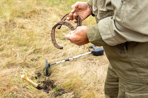 Man with electronic metal detector device working on outdoors