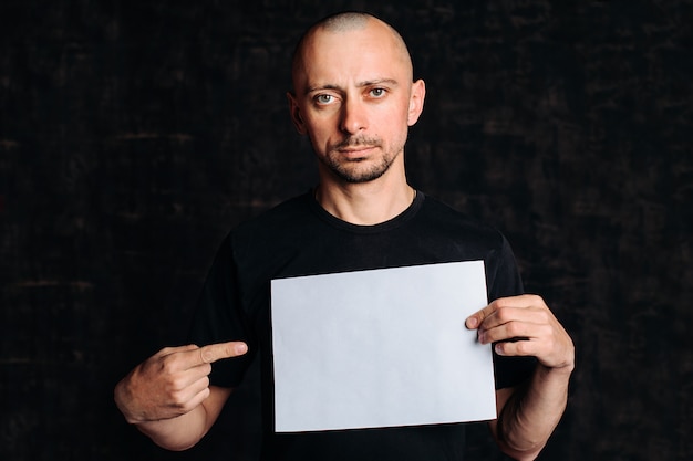 man with an empty white banner