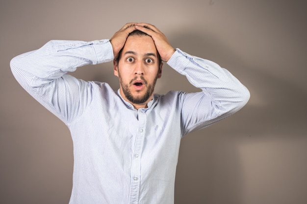 Man with expression of amazement and hands on his head