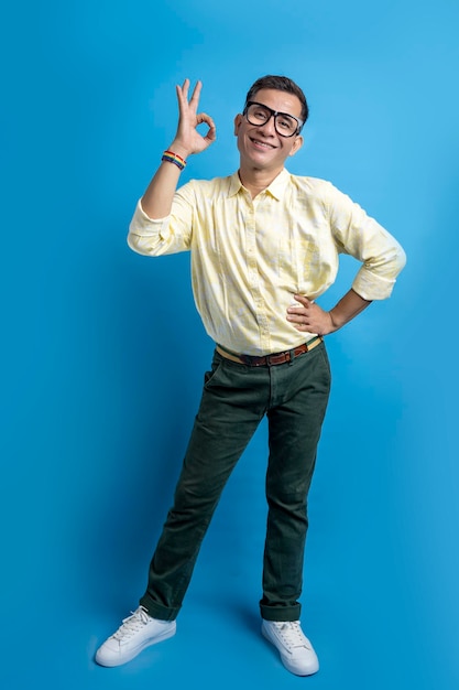 Man with eyeglasses and a shirt wearing a rainbow bracelet