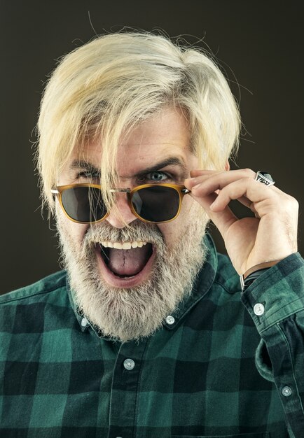 Man with fashion sunglasses portrait of handsome man against grey wall portrait of attractive  year ...