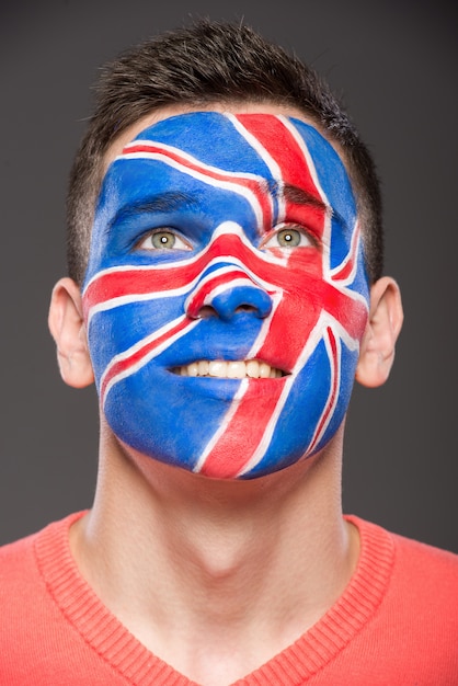 Man with flag painted on his face to show UK.