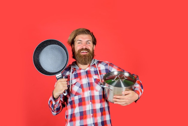 Man with fry pan and saucepan happy chef with frypan saucepan frypan cooking kitchenware cooking