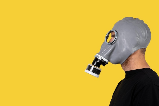 Man with a gas mask on yellow background