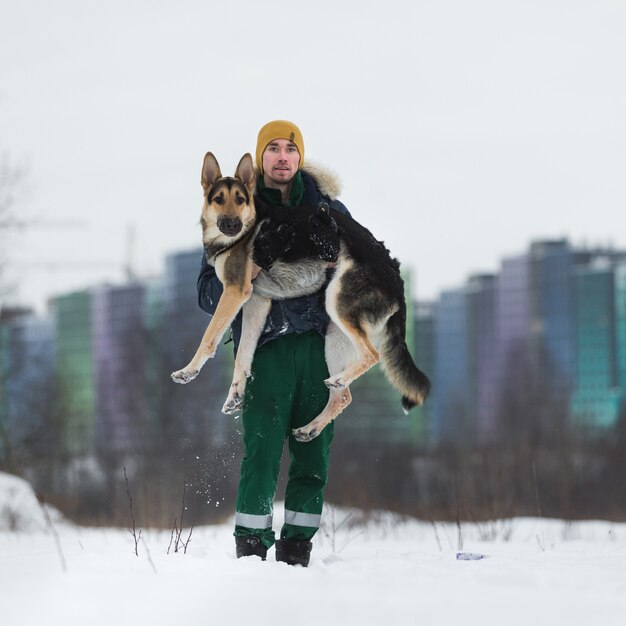 Man with a German shepherd in the Park in the winter