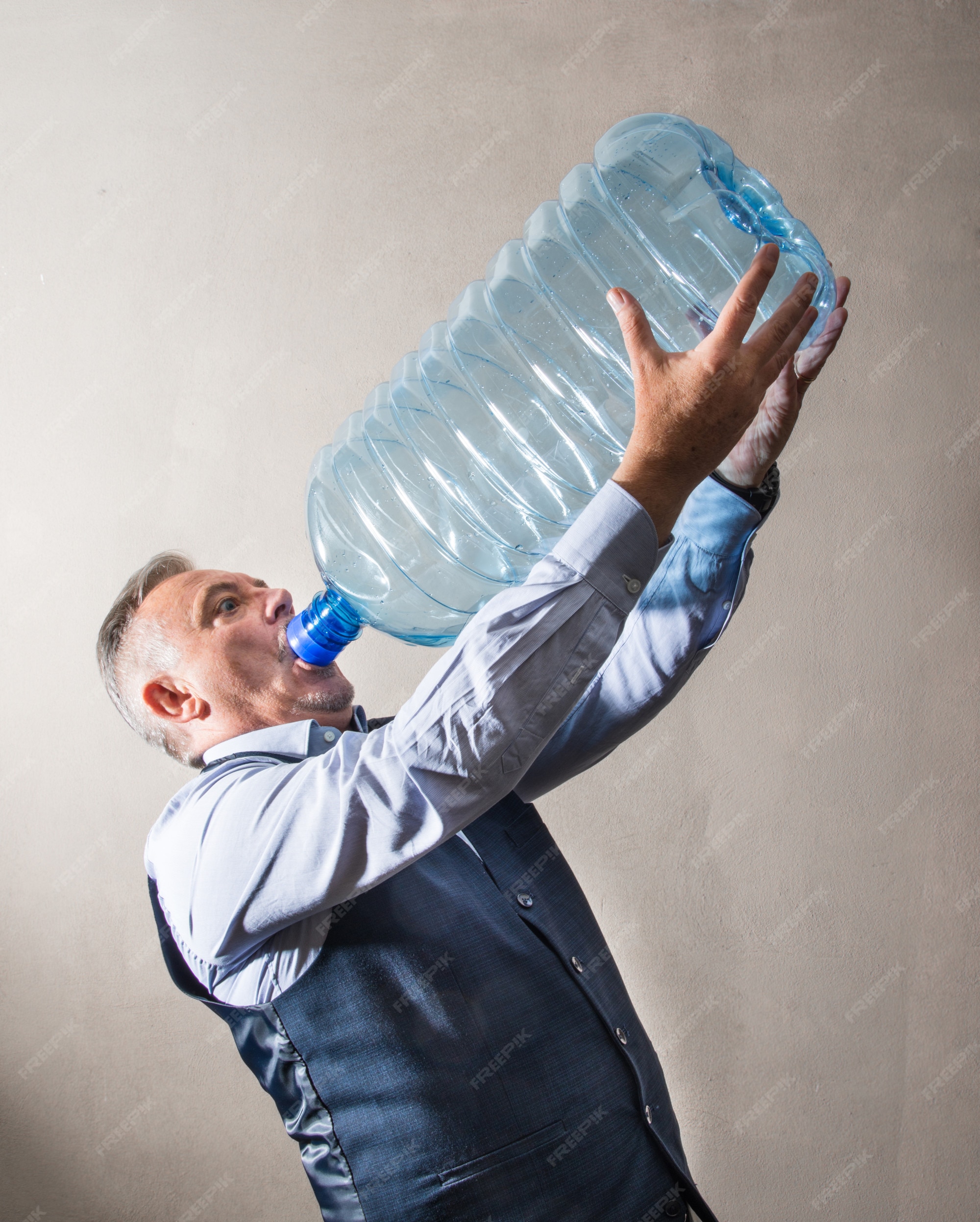 Premium Photo  Man with a giant water bottle