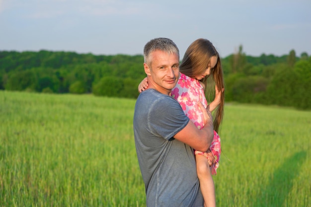 Man with a girl outdoors.