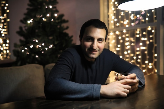 Man with glass of whisky in the pub on night