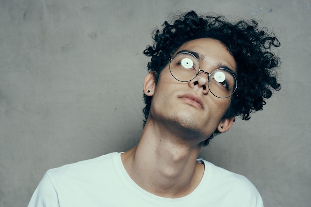 Man with glasses curly hair attractive look cropped look fashion yes High quality photo