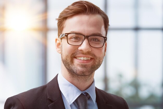 A man with glasses feels confident in the office