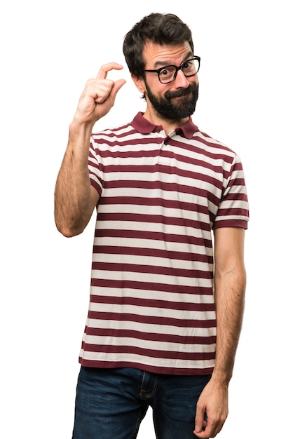 Man with glasses making tiny sign