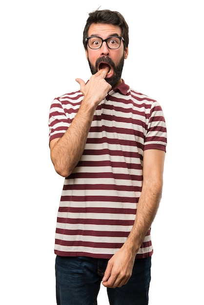 Man with glasses making vomiting gesture