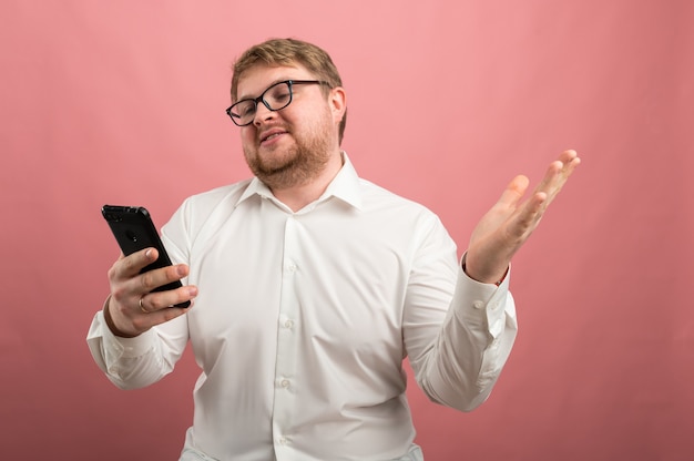 A man with glasses talks on video communication and swears