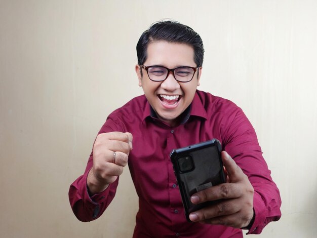 Man with glasses wearing red shirt with expression