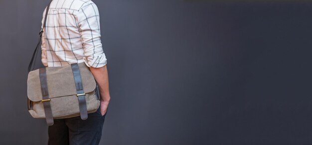 Man with a gray canvas messenger bag