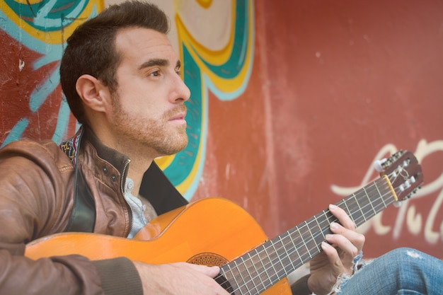 man with guitar in a ruined building