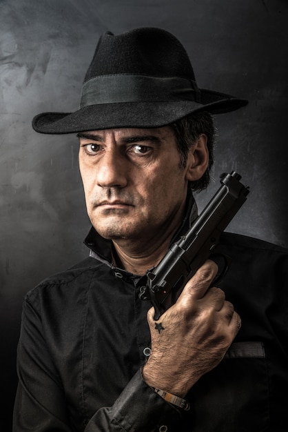 Man with gun and serious look