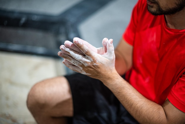 Man with hands covered with white magnesium powder