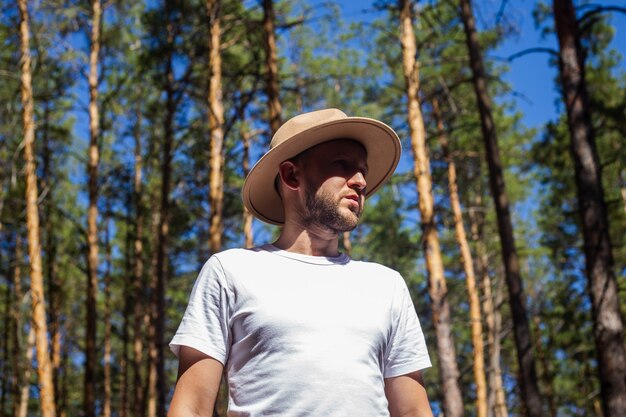 Man with a hat in the forest. Hike in the mountains, forest.