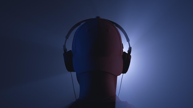 A man with headphones in the beams of a searchlight Back view