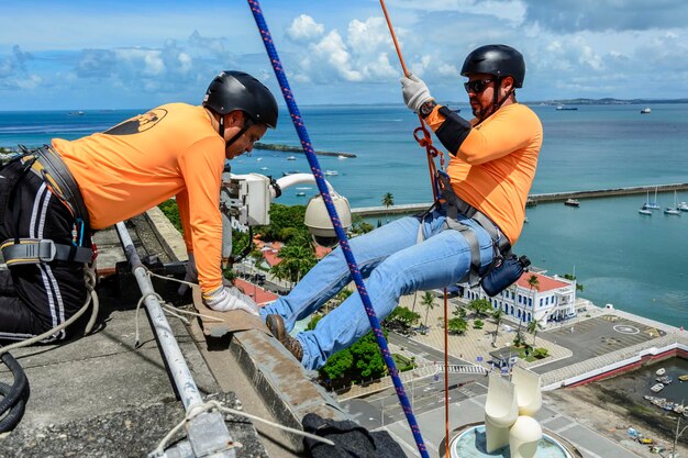 Man with helmet glove and equipment practicing rappel on\
elevador lacerda the postcard of salvador bahia brazil