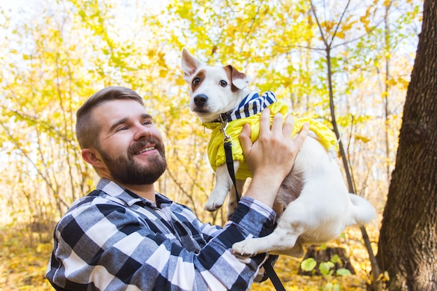 Man with his dog at autumn park