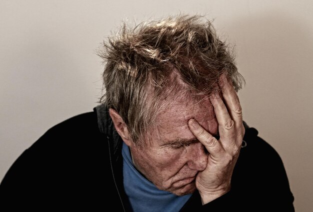 a man with his hand on his head