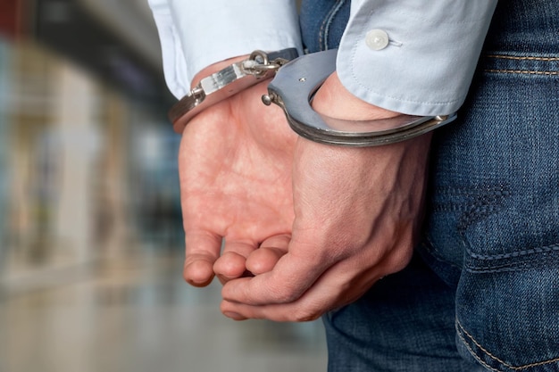 Man with his hands handcuffed in criminal